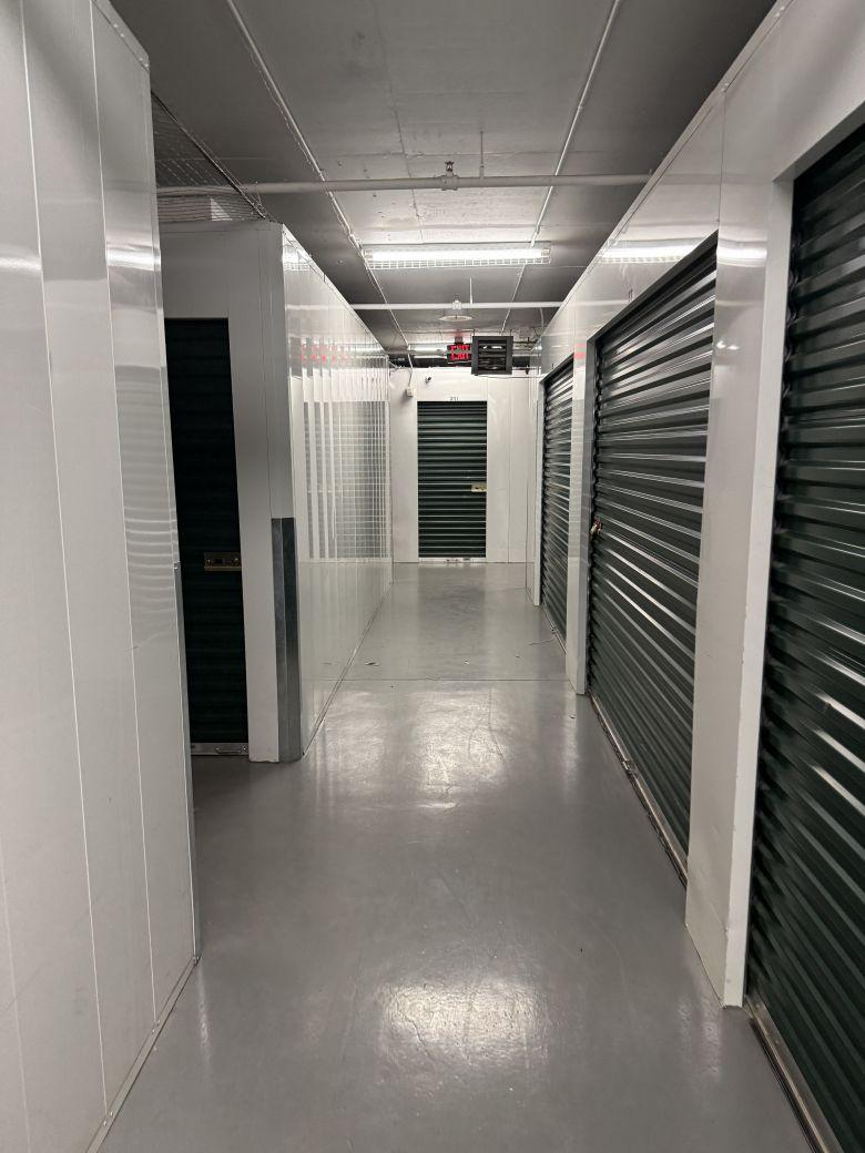 A hallway depicting several indoor climate-controlled storage units in Avon