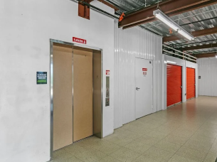 A hallway with elevator access and climate-controlled storage units in Rockledge, FL