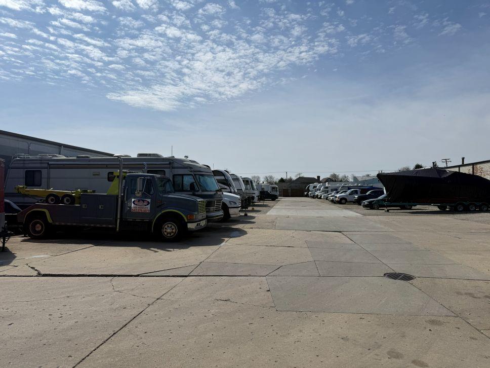 Outdoor vehicle storage in Arlington Heights, featuring RVs, trailers, boats, cars, and commercial vehicles