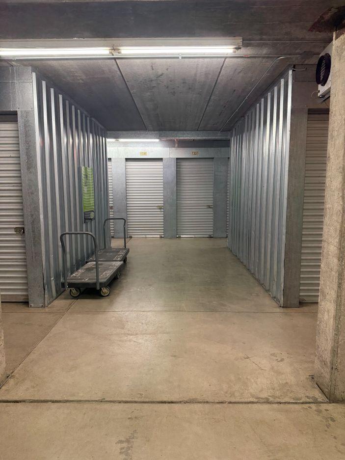 Carts and dollies in a hallway with climate-controlled storage units