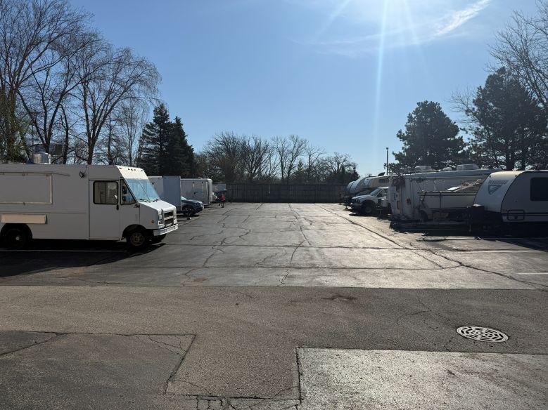 Outdoor vehicle storage in West Chicago depicting various trailers, campers, cars, and commercial vehicles
